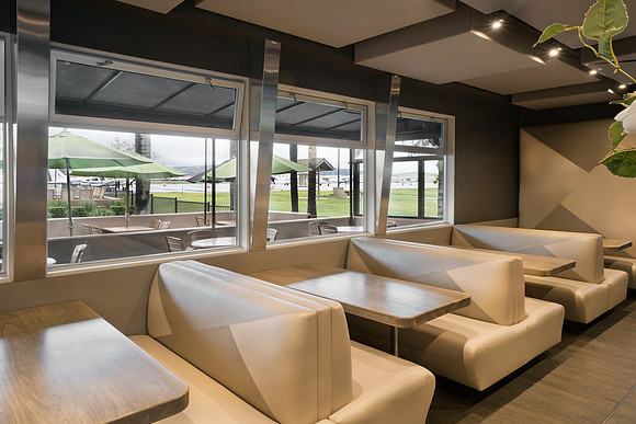 Booths overlooking the runway area with custom metal window