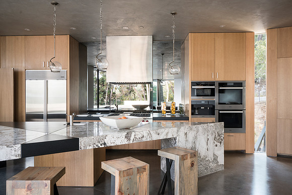 view of asymetrical kitchen island with custom seating